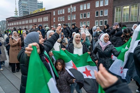 Syrian woman celebrate the end of the Assad regime after the change of power in Syria at a rally on