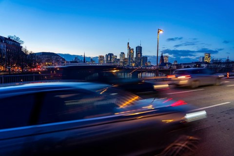Skyline of the city centre of Frankfurt am Main, road traffic, car, on the raft bridge, dusk, river