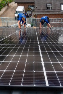 Installation of solar modules on the roof of a barn on a farm, over 240 photovoltaic modules are