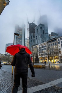 Rainy weather, freezing rain, Goetheplatz, high-rise skyline in clouds, passers-by hurrying through