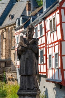 Monreal, idyllic half-timbered village in the Elz valley, figure of Nepomuk, the bridge saint, in