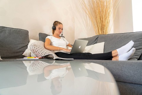 Young student learns at home, online, in conversation with other students