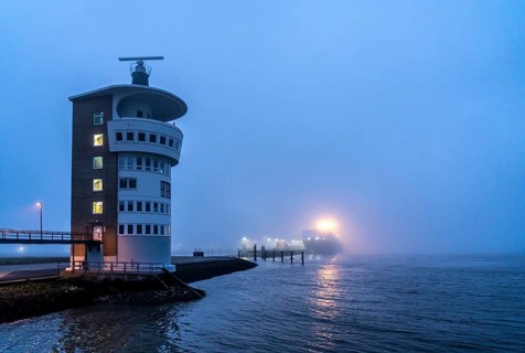 Thick fog in winter, hanging over the mouth of the Elbe into the North Sea, radar tower of the