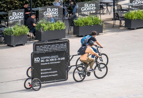 Mobile billboards, pulled by bicycles, advertising for the Kö-Galerie shopping centre in North