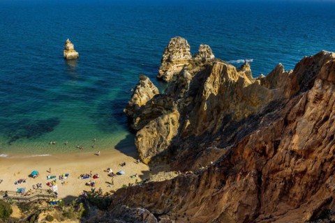Rocky coast with beach and red rocks, Praia do Camilo, Lagos, Algarve, Portugal, Europe
