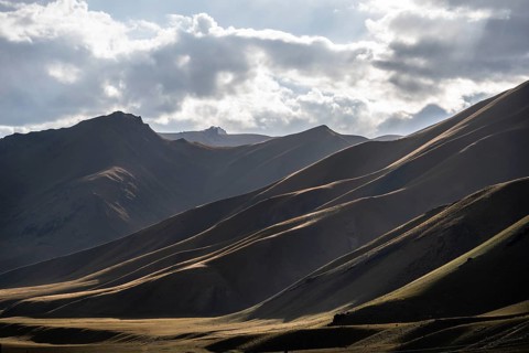 Mountain silhouette and hills in the sunlight, Dramatic mountain landscape, Tian Shan, Sky