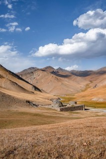 Historic caravanserai Tash Rabat from the 15th century, with yellow hills, Atbashy district in the