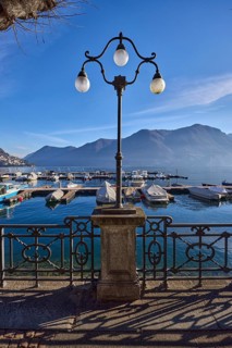 Lantern, forged railing, lakeside promenade, shadow, marina, tree, motorboats, haze, mountain,