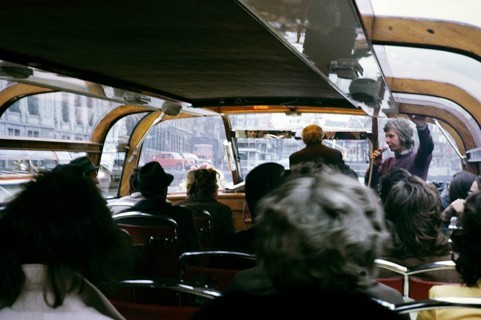 People sitting inside boat trip tour through the city centre Amsterdam, Netherlands 1973 Tour guide