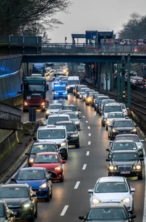 Traffic jam on the A40 motorway, emergency lane, vehicles on the left and right, police patrol car