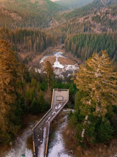 Snow-covered wooden platform surrounded by forest with panoramic view, Ellbachseeblick viewing