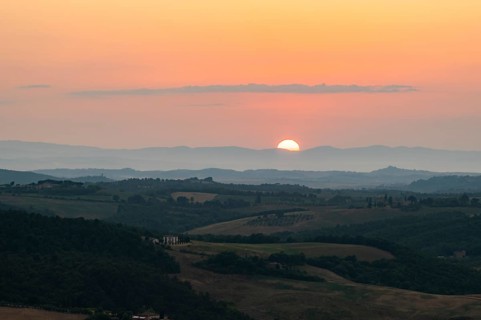 View from Montepulciano into a typical Tuscan landscape in Val d'Orcia with hills, trees, fields,