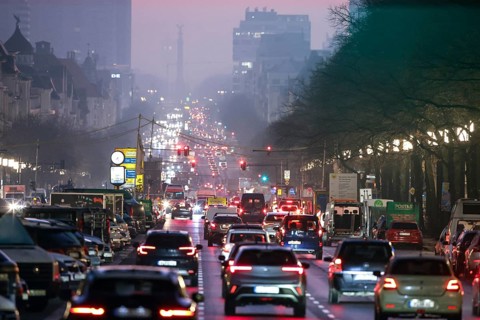 Busy Kaiserdamm and Bismarckstraße during morning rush hour in foggy and cloudy winter weather,
