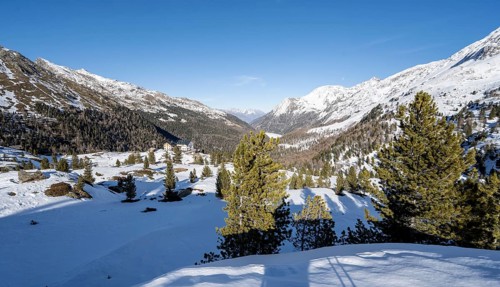 Zufallhütte mountain hut, view of the Martell Valley, snow-covered mountain landscape in winter,