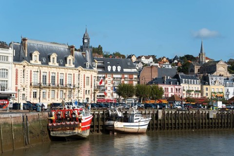 Historic harbour with fishing boats and church towers under a sunny sky, Trouville-sur-Mer,