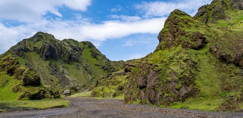 Stream bed in a green moss-covered gorge, enchanted volcanic landscape, Pakgil, Iceland, Europe