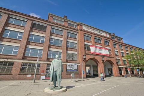 Adam Opel memorial, bronze statue in front of the old Opel main portal, Bahnhofsplatz, Rüsselsheim,