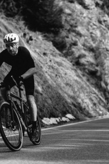 Road bike rider in spring in the Allgäu against the picturesque backdrop of the Alps, Bavaria,