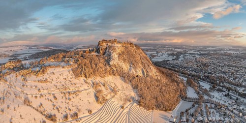 Aerial view, panorama of the snow-covered Hegau volcano Hohentwiel with Germany's largest castle