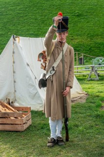 Reenactor in French Line Infantry uniform loading Napoleonic flintlock muzzle-loaded musket at the