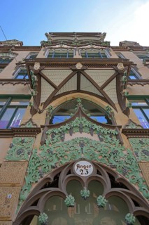 Oriel with decorations on historic commercial building, view upwards, detail, inscription, house