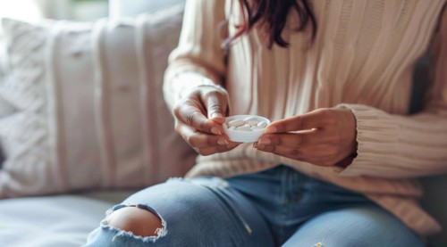 Woman with painkillers suffering for menstrual or stomach pain or other sickness. Overmedication,