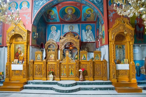 Ornamented Orthodox church altar with icons and golden wooden decoration, pilgrimage church of Agia
