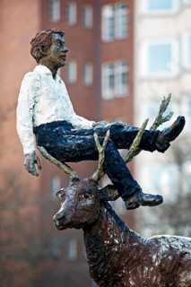 Sculpture by Stephan Balkenhol entitled Man with stag, painted bronze, surreal combination,