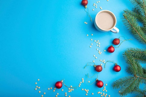 Christmas or New Year composition. Decorations, red balls, fir and spruce branches, cup of coffee,