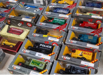 A selection of boxed Corgi model vehicles on display in auction room, UK