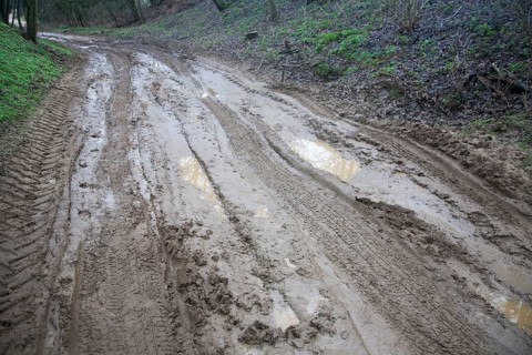 Waterlogged muddy unsurfaced road after heavy rain in Suffolk, England, United Kingdom, Europe