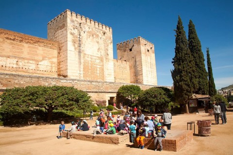 Fortified walls of the Alcazaba castle in the Alhambra complex, Granada, Spain with a group of