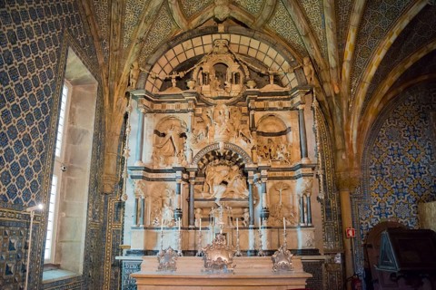 Decorative interior of a church with elaborately decorated altar and architectural works of art,