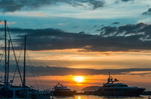 Sunset with cloud sky on the pier with yachts