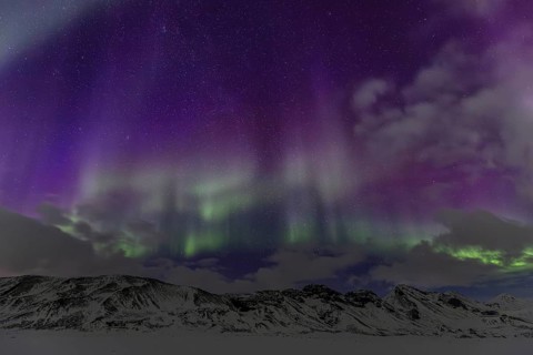 Green and purple northern lights, aurora borealis over snowy mountains, volcanic, winter, moon,
