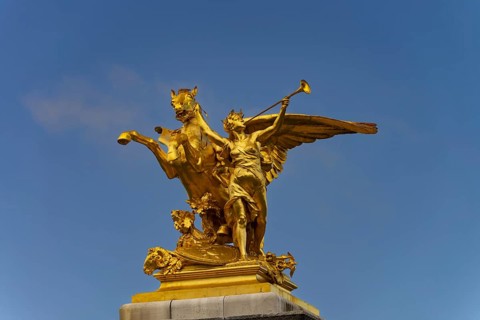 Column with the group of figures Fama of War on the Pont Alexandre III bridge over the Seine,