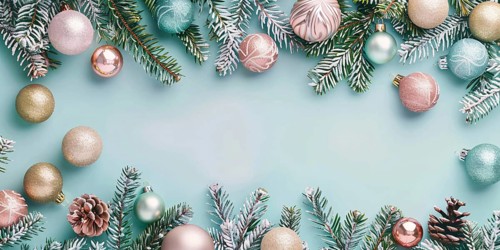 Christmas flatlay with blue, gold and pink colored tree baubles with fir branches on pastel