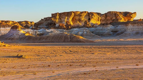 Eroded rock formations on a fossilised reef edge, at blue hour, Huqf stone desert, Arabian