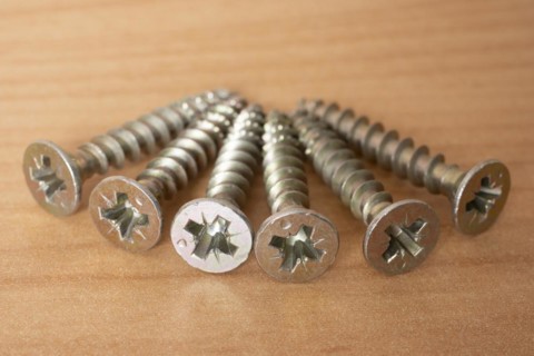 Phillips screws on wooden background, wood screws, spax screws