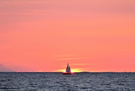 Sailboat sailing in the evening towards the setting sun, Baltic Sea, Poel Island,