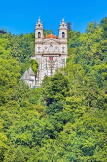 View of Bom Jesus do Monte santuary immersed in the greenery of the surrounding woods, Braga, Minho