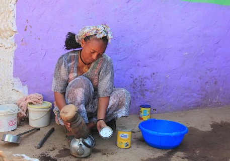 In the highlands of Abyssinia, in the village of Sina, young woman prepares coffee for the coffee