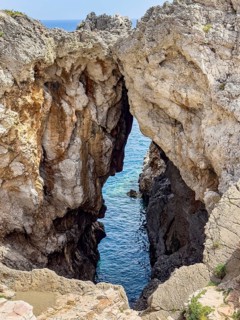 View of striking rock with narrow crevice at the exit of Avios Pavlos Bay, Agios Pavlos, Crete,