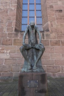 Bronze sculpture of Job, created by the German sculptor Gerhard Marcks in 1957, in front of St