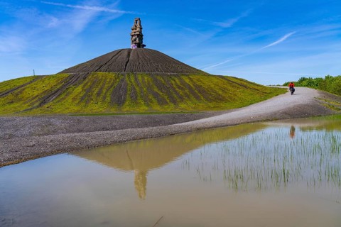 Cyclist on the Rheinelbe spoil tip in Gelsenkirchen, 100 metre high spoil tip, landscape park, with