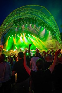 At night at the open-air concert with green lighting, crowd and stage, Klostersommer, Calw Hirsau,
