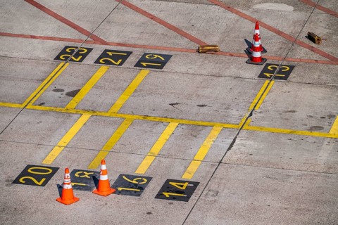 Park markings on the ground, at the terminal, in front of the passenger boarding bridge, holding