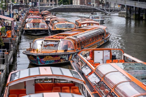 Canal cruises, pier of Lovers Canal Cruises, at Amsterdam Centraal station, Amsterdam Netherlands