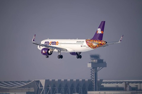 Air Cairo Airbus A320neo approaching Frankfurt FRA airport, air traffic control tower, Fraport, in