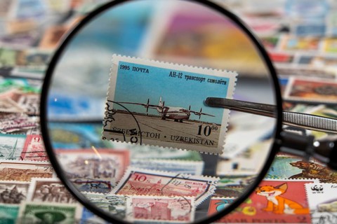 Stamp collection, collecting, postage stamps, postage stamps from different countries, magnifying